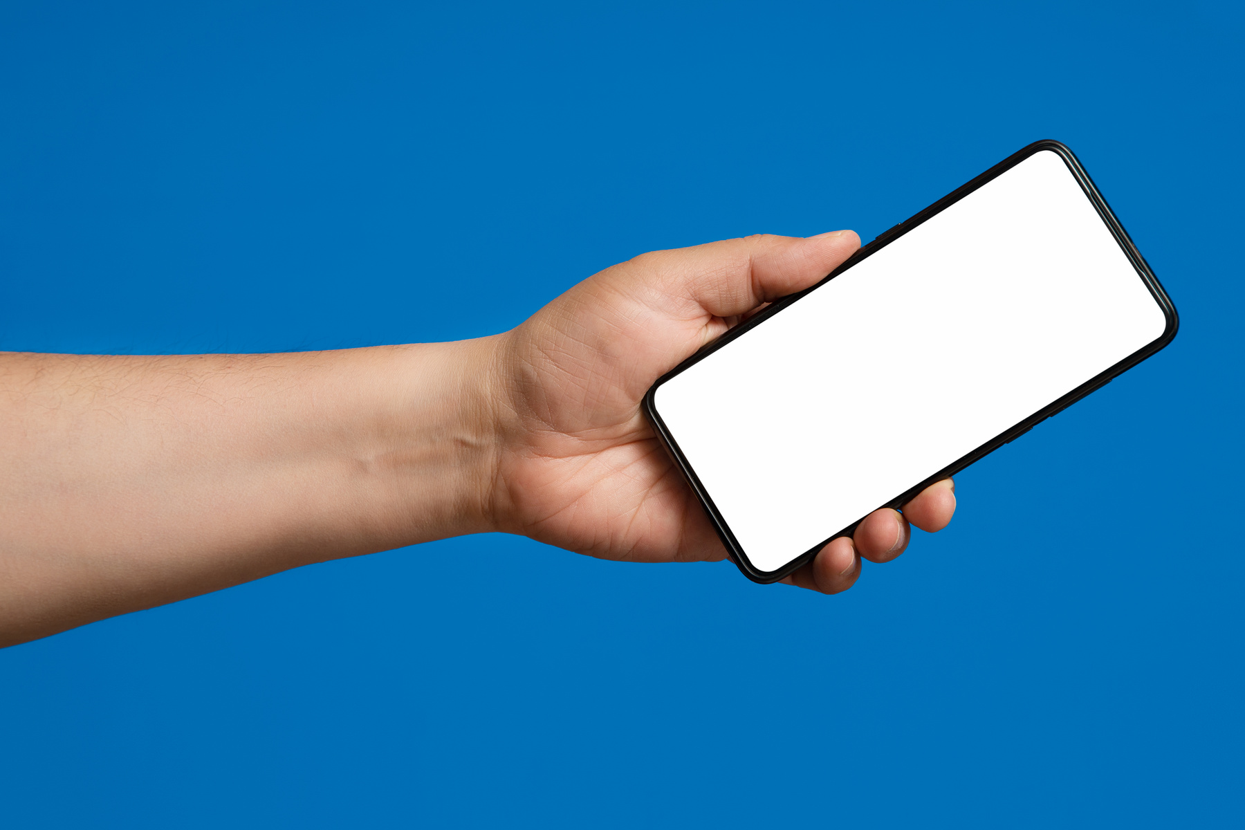 Hand with Phone on Blue Background